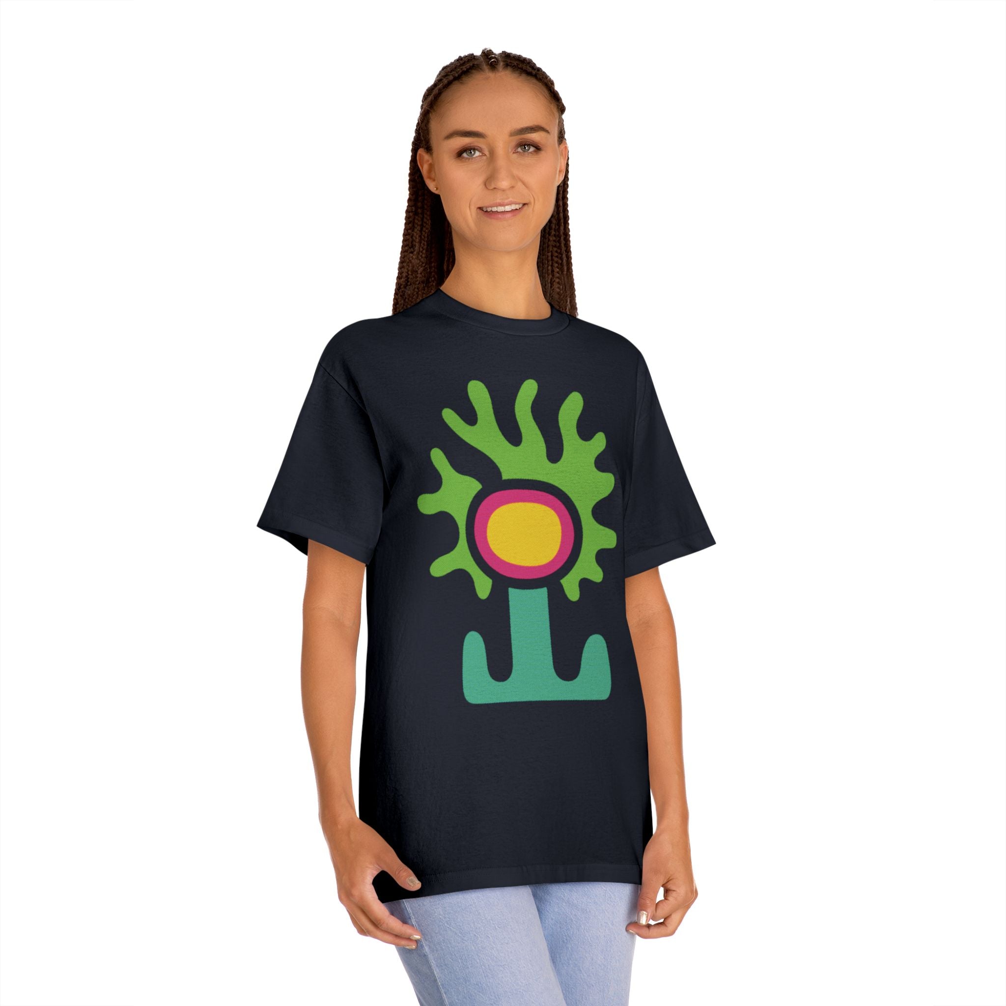 Woman wearing the black Abstract Alien Flower tee, showcasing the vibrant green graphic against the dark fabric