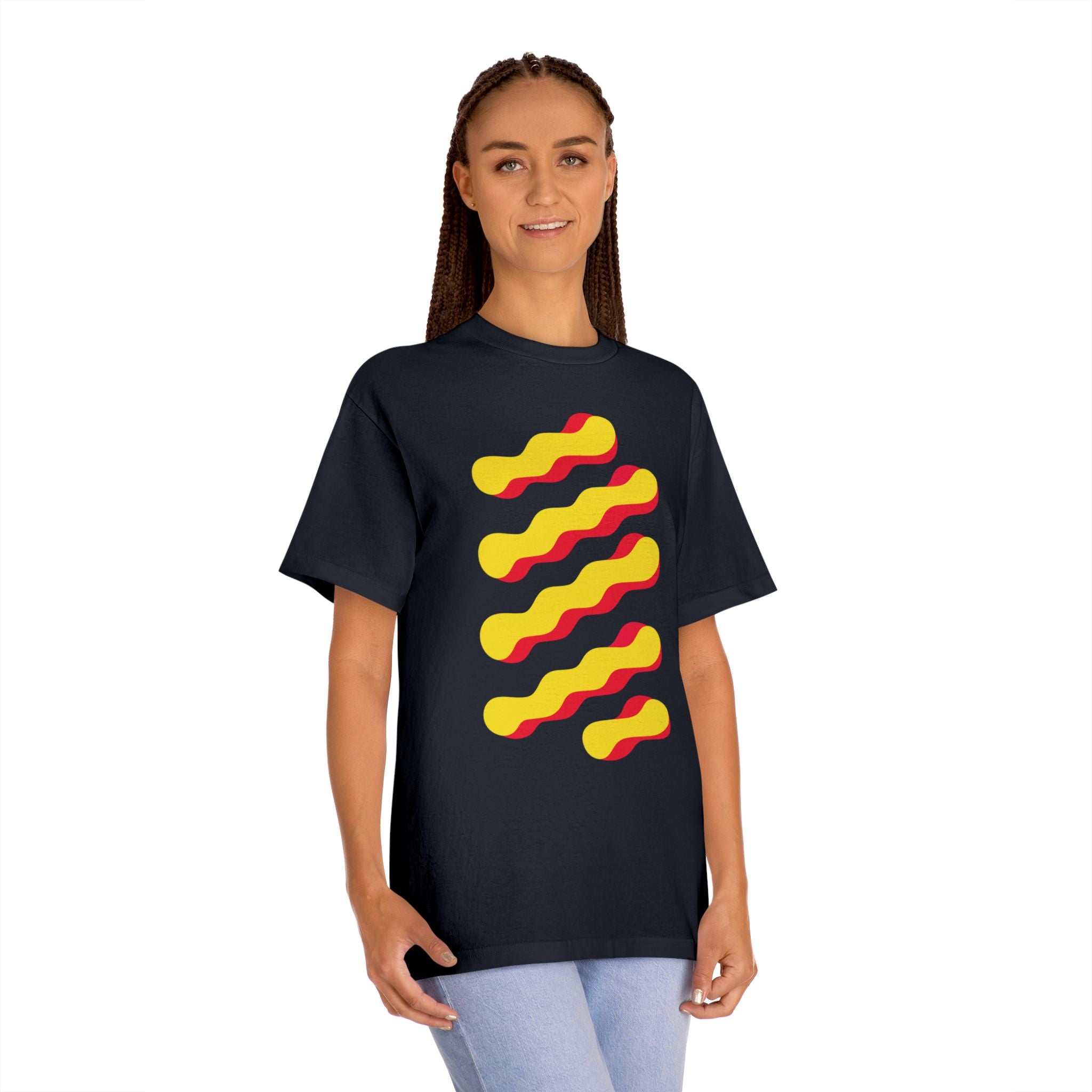 Woman wearing the black abstract graphic tee, featuring retro yellow and red wave design