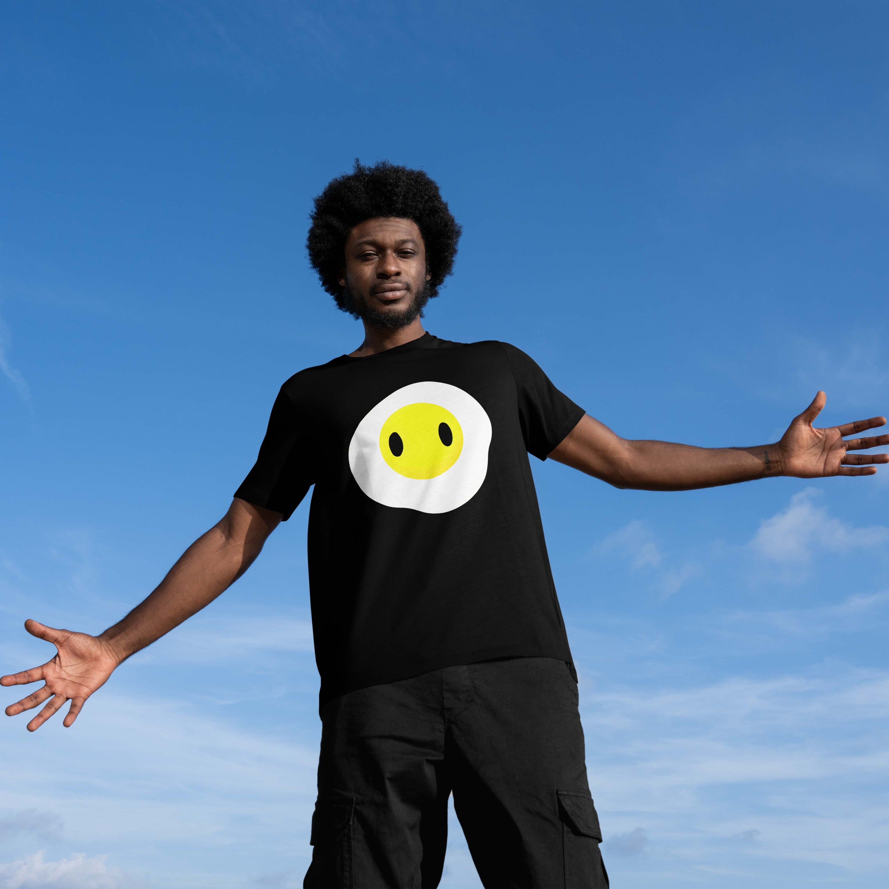 man wearing the black Fried Egg graphic tee, showcasing the cute breakfast character print and casual streetwear fit