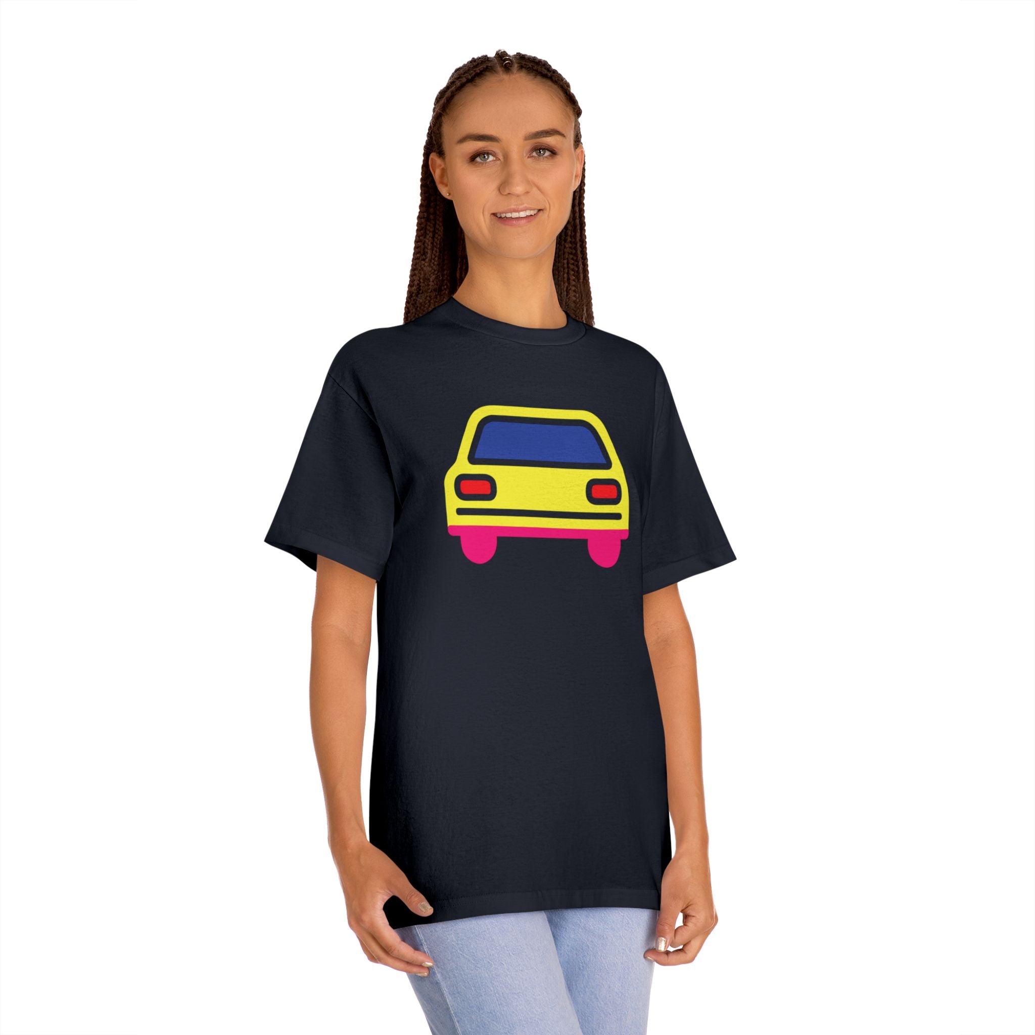 Woman wearing oversized black graphic t-shirt with yellow pop art car design. Relaxed streetwear fit on female model. Casual indie fashion style
